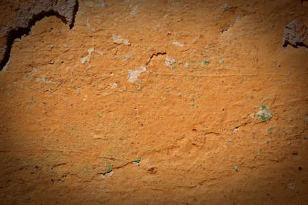 The old wall covered with plaster crashed