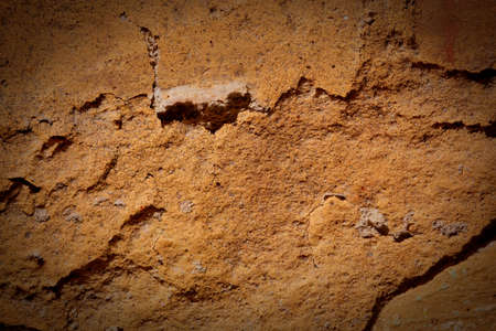 The old wall covered with plaster crashed