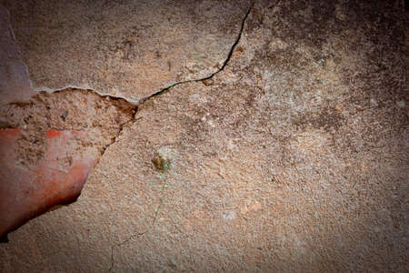 The old wall covered with plaster crashed