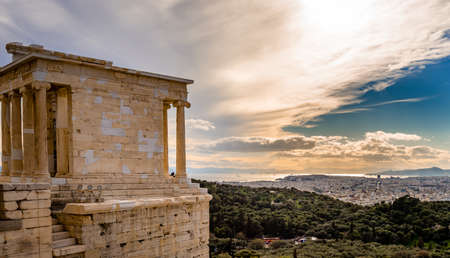 The Temple of Athena Nike, on the Acropolis of Athens, Greece, named after the Greek goddess Athena. Philopappos Hill and Piraeus is in the background.の写真素材