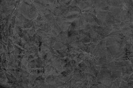 old black paper with cracked torn textureの写真素材