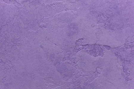 purple background with painted cracked plaster wall texture designの写真素材