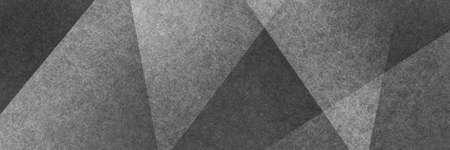 Abstract modern background in black and white colors and contemporary triangle square and block shapes layered in random geometric art pattern with fine textureの写真素材