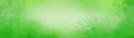 Lime green background. Watercolor background in bright green blotches with texture grunge and white center with cloudy painted border design. Green paper or background.の写真素材