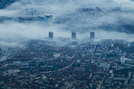 The three buildings of Grenoble in the morning fog.の写真素材