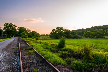 Sunset over railroad tracks and fields in York County, Pennsylvania.の写真素材
