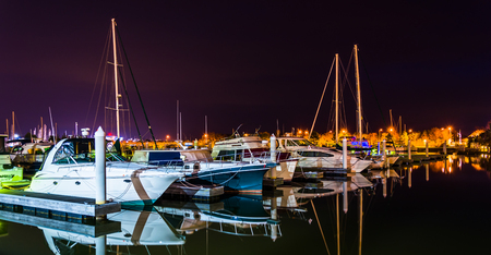 Boats reflecting in the water at night, in a marina on Kent Island, Maryland.のeditorial素材