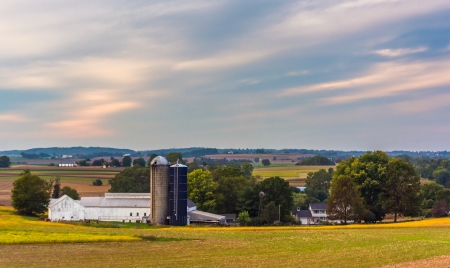 View of a barn and silos on a farm in rural Lancaster County, Pennsylvania.の写真素材