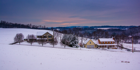 Snow covered fields and rolling hills in rural Carroll County, Maryland.の写真素材