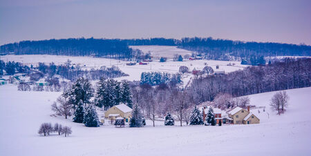 Snow covered fields and rolling hills in rural York County, Pennsylvania.の写真素材