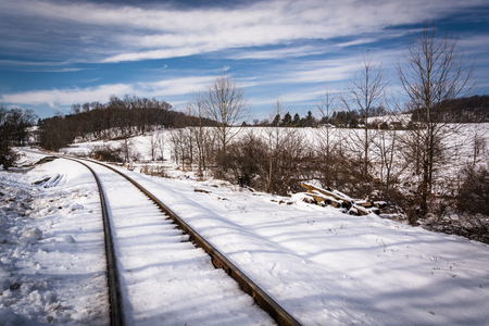 Snow covered railroad tracks in rural Carroll County, Maryland.の写真素材