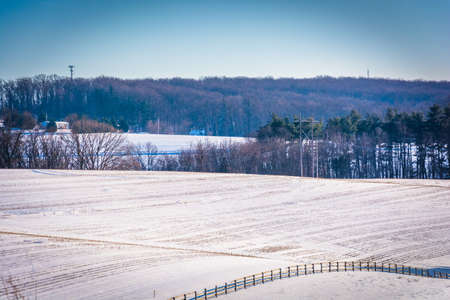 View of snow-covered farm fields in rural York County, Pennsylvania.の写真素材