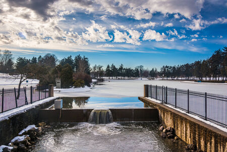 Spillway at Kiwanis Lake, seen during the winter in York, Pennsylvania.の写真素材
