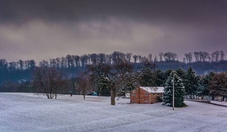 House and snow covered field in rural York County, Pennsylvania.のeditorial素材