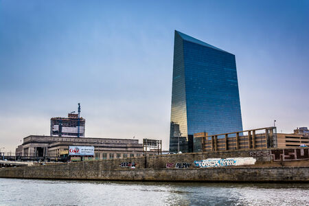 Skyscraper and graffiti on wall along the Schuylkill River in Philadelphia, Pennsylvania.のeditorial素材
