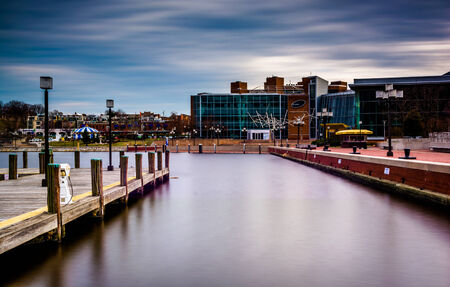 Long exposure of a pier and the Maryland Science Center at the Inner Harbor in Baltimore, Maryland.のeditorial素材