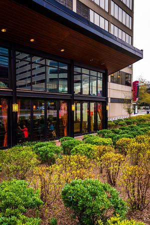 Bushes and a modern building in downtown Baltimore, Maryland.のeditorial素材