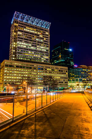 Elevated walkway and modern skyscrapers at night in Baltimore, Maryland.のeditorial素材