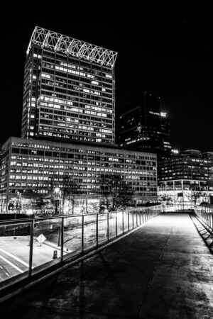 Elevated walkway and modern skyscrapers at night in Baltimore, Maryland.のeditorial素材