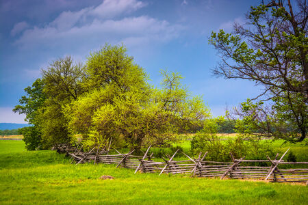 Storm clouds over trees and  fence in Gettysburg, Pennsylvania.の写真素材