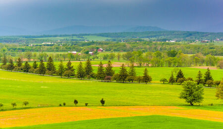 Storm clouds over fields and distant mountains seen from Longstreet Observation Tower in Gettysburg, Pennsylvania.の写真素材