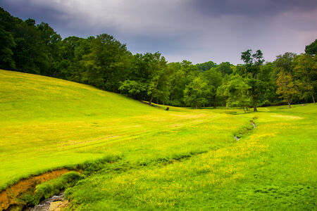 Small stream and farm field in rural Baltimore County, Maryland.の写真素材