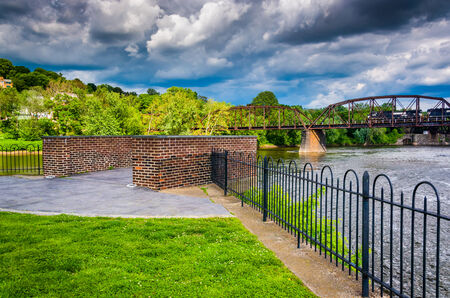 Storm clouds over the Delaware River and a train bridge in Easton, Pennsylvania.の写真素材