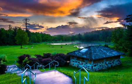 Sunset over building and ponds at Delaware Water Gap National Recreational Area, New Jersey.の写真素材