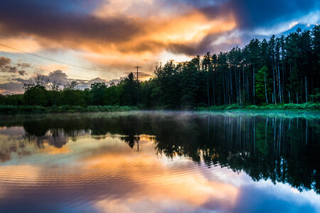 Sunset sky reflecting in a pond at Delaware Water Gap National Recreational Area, New Jersey.の写真素材