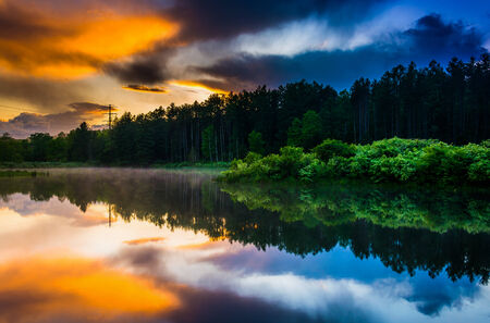 Sunset sky reflecting in a pond at Delaware Water Gap National Recreational Area, New Jersey.の写真素材