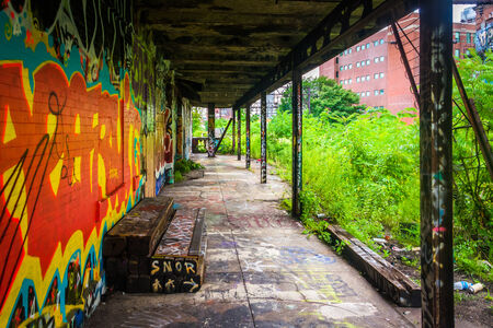 An old, graffiti-covered building at the Reading Viaduct in Philadelphia, Pennsylvania.のeditorial素材