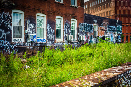 Graffiti on an old brick building, seen from the Reading Viaduct in Philadelphia, Pennsylvania.のeditorial素材