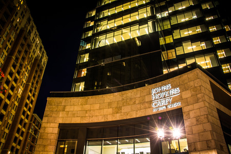 John Hopkins Carey Business School at night in Harbor East, Baltimore, Maryland.のeditorial素材