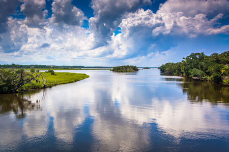 Clouds reflecting in the Tomoka River, at Tomoka State Park, Florida.の写真素材
