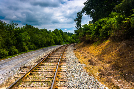 Railroad track and dirt road in rural Carroll County, Maryland.の写真素材