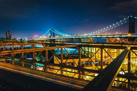 The Manhattan Bridge, seen from the Brooklyn Bridge at night, New York.の写真素材