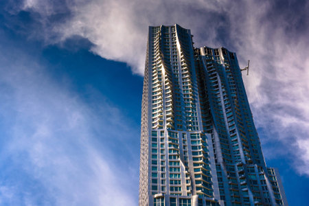 Top of a skyscraper and wispy clouds in Lower Manhattan, New York.