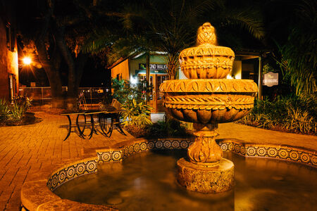 Fountain and shops at night in St. Augustine.のeditorial素材
