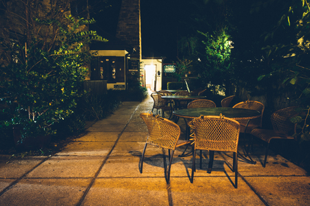Tables and chairs outside a restaurant at night, in St. Augustine, Florida.のeditorial素材