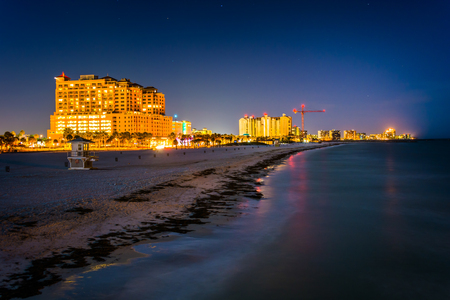 View of beachfront hotels and the beach from the fishing pier at night in Clearwater Beach, Florida.の写真素材