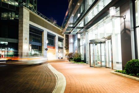 Modern buildings at night along a street in Baltimore, Maryland.の写真素材