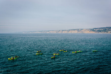 Kayakers in the Pacific Ocean, seen from La Jolla, California.の写真素材