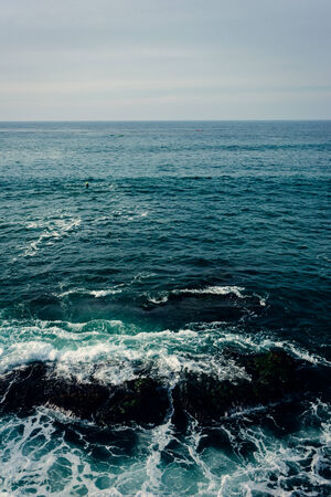 Rocks and waves in the Pacific Ocean, seen from La Jolla, California.