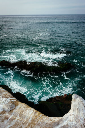 Rocks and waves in the Pacific Ocean, seen from La Jolla, California.の写真素材