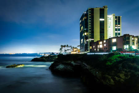 View of a building and cliffs along the Pacific Ocean at night in La Jolla, California.の写真素材