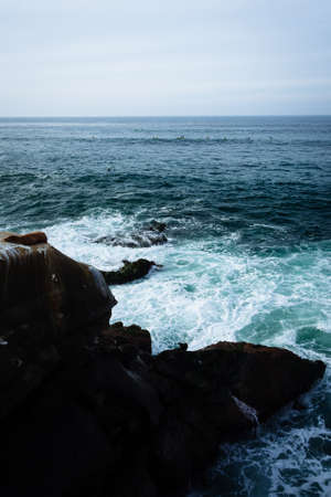 View of waves and rocks in the Pacific Ocean, seen from La Jolla, California.の写真素材