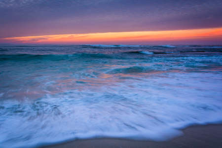 Waves in the Pacific Ocean at sunset, in La Jolla, California.の写真素材