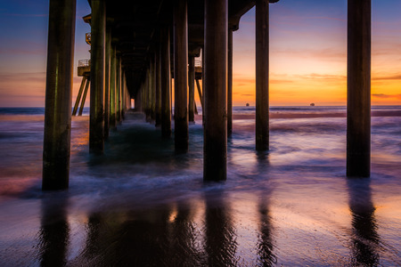 Under the pier at sunset, in Huntington Beach, California.の写真素材
