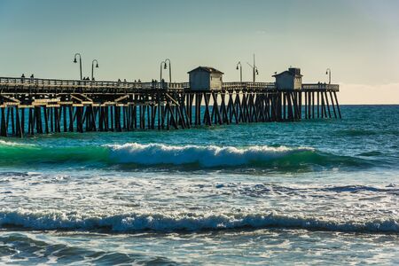 Waves in the Pacific Ocean and the fishing pier in San Clemente, California.