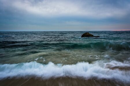 Waves crashing the shore at Woods Cove, in Laguna Beach, California.の写真素材